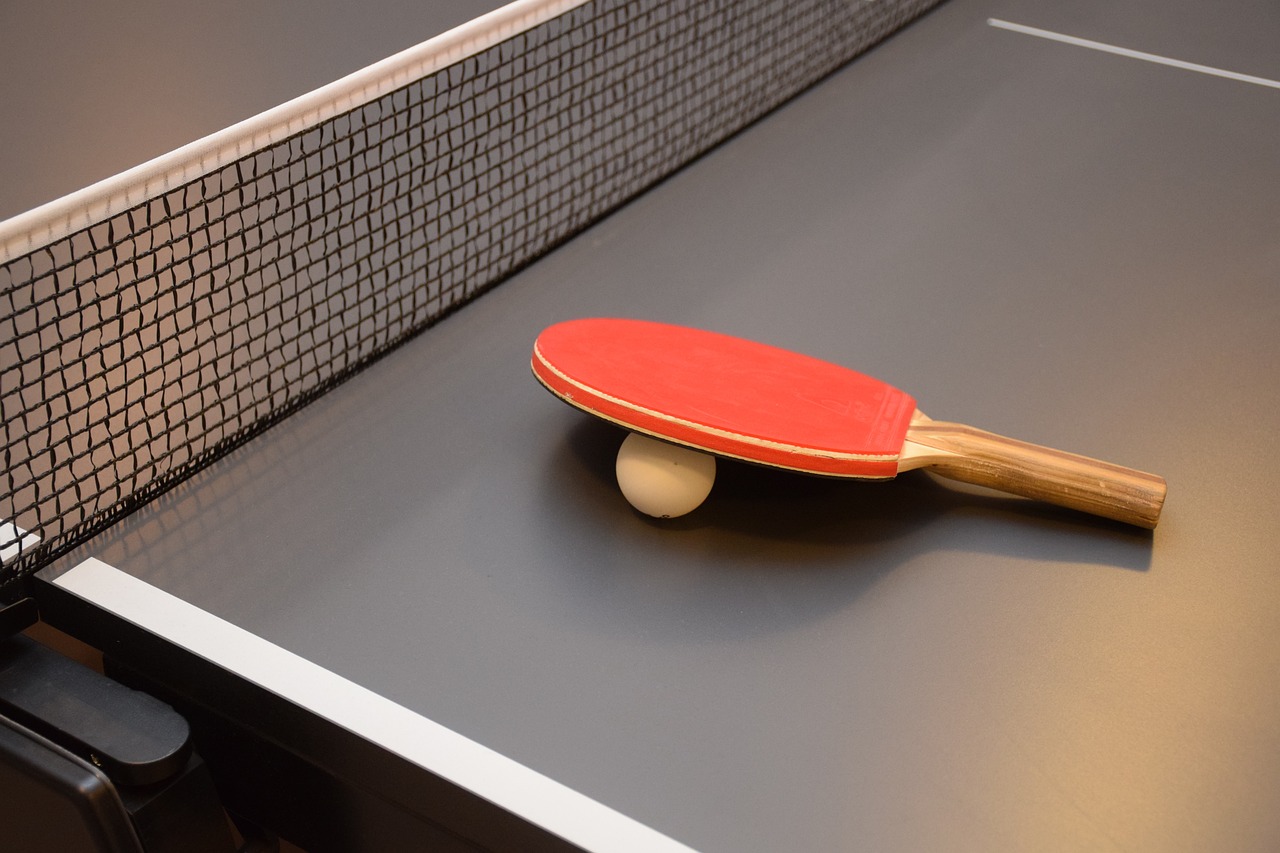 Table tennis table with paddle and ball